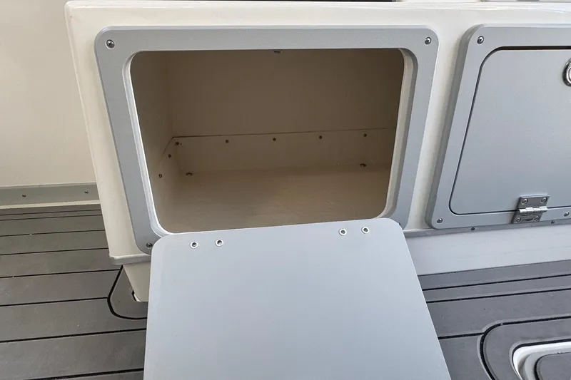 Slide: The Image of Open storage compartment on 2025 Defiance Admiral 250 EX boat deck. - 70
