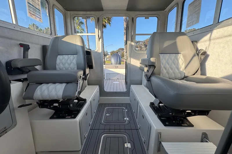 Slide: The Image of Interior of 2025 Defiance Admiral 250 EX boat with two cushioned seats. - 72