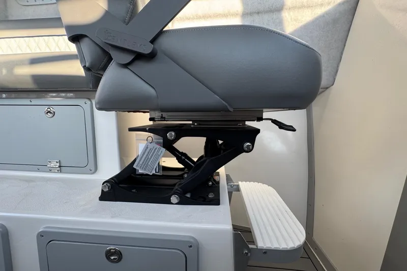 Slide: The Image of Captain's seat in 2025 Defiance Admiral 250 EX boat, featuring adjustable pedestal and footrest. - 73