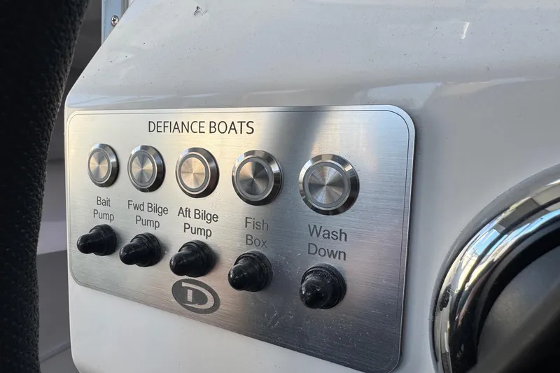 Slide: The Image of Control panel of 2025 Defiance Admiral 250 EX boat with pump switches. - 84