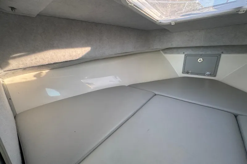 Slide: The Image of Interior cabin of 2025 Defiance Admiral 250 EX boat with cushioned seating. - 90