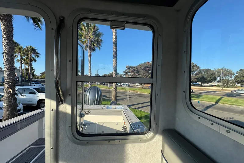 Slide: The Image of Interior view of 2025 Defiance Admiral 250 EX boat with window and outdoor scenery. - 96