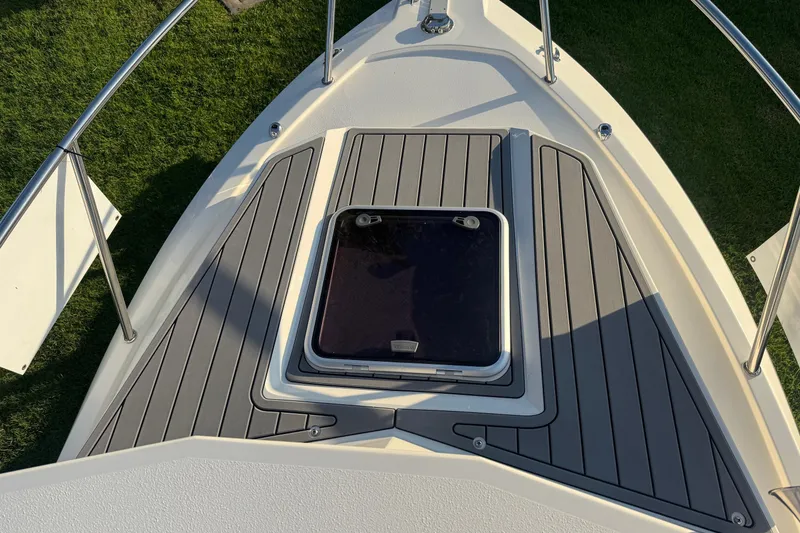 Slide: The Image of Bow deck of 2025 Defiance Admiral 250 EX with hatch and sleek design. - 98