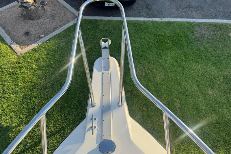 Slide: The Image of Bow view of 2025 Defiance Admiral 250 EX boat with stainless steel railings. - 99