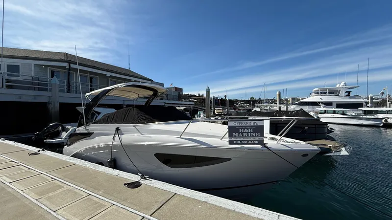 Slide: The Image of 2025 Regal 26 XO boat docked at marina under clear blue sky. - 10