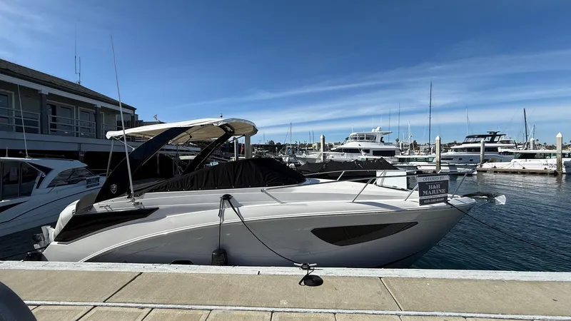 Slide: The Image of 2025 Regal 26 XO boat docked at marina under clear blue sky. - 11