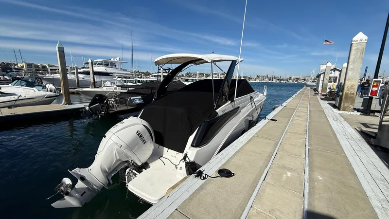 Slide: The Image of 2025 Regal 26 XO boat docked at marina with Yamaha outboard motor. - 13