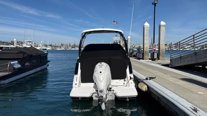 Slide: The Image of 2025 Regal 26 XO boat docked at marina with clear blue sky. - 14