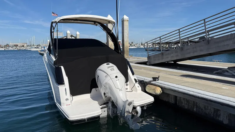 Slide: The Image of 2025 Regal 26 XO boat docked at marina, featuring sleek design and powerful outboard motor. - 15