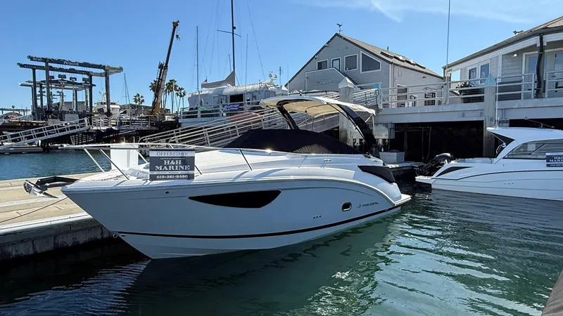 Slide: The Image of 2025 Regal 26 XO boat docked at a marina, with modern design and sleek lines. - 17