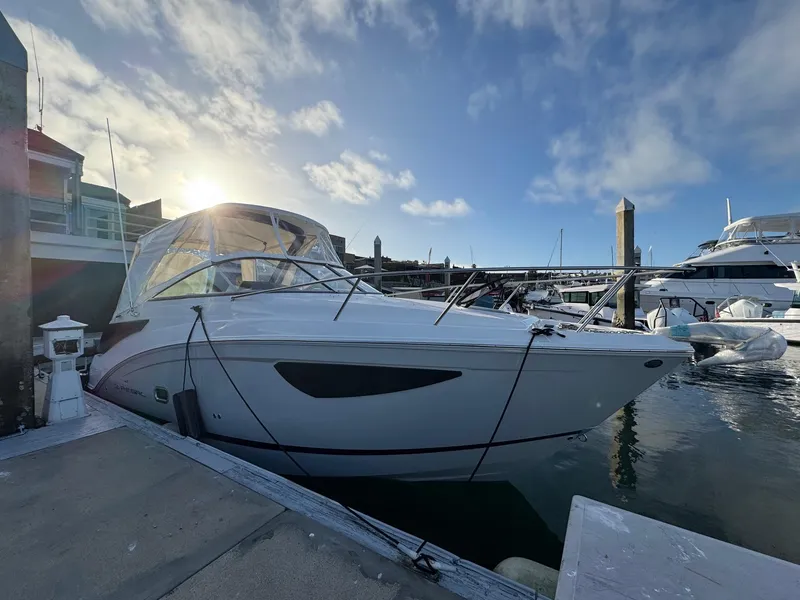 Slide: The Image of 2025 Regal 26 XO boat docked at marina under clear blue sky. - 18