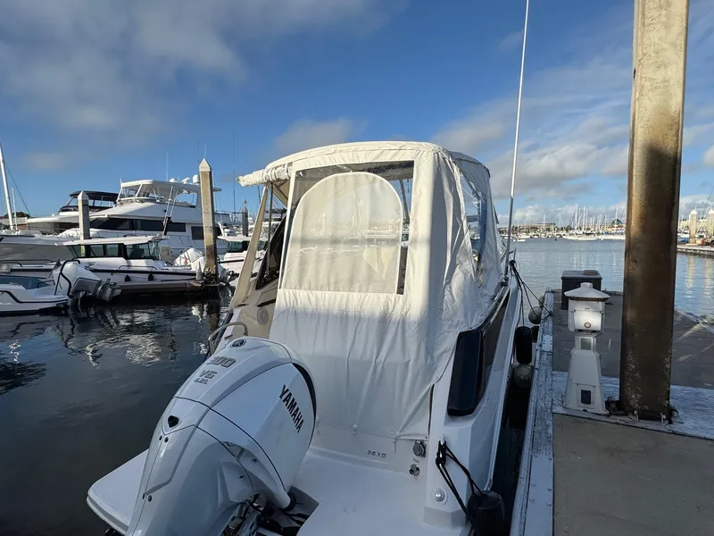 Slide: The Image of 2025 Regal 26 XO boat docked with Yamaha outboard motor, marina background. - 20