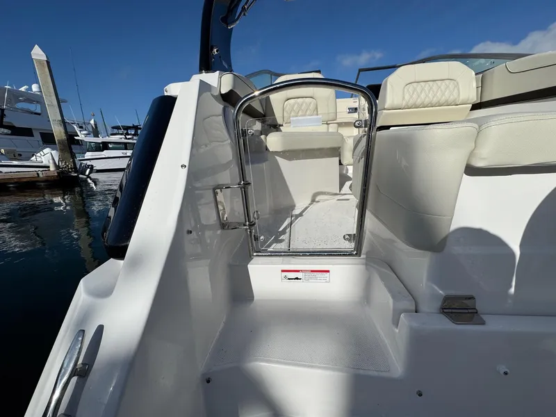 Slide: The Image of 2025 Regal 26 XO boat interior with white seating and glass door. - 25