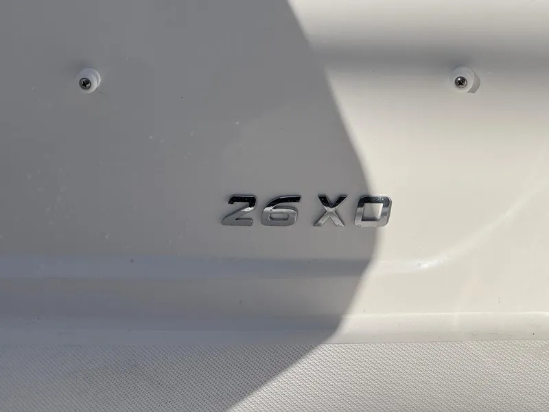 Slide: The Image of 2025 Regal 26 XO boat model emblem on white surface. - 26