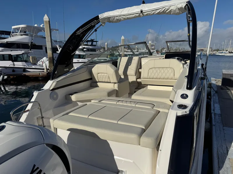 Slide: The Image of 2025 Regal 26 XO boat with luxurious seating docked at a marina. - 28