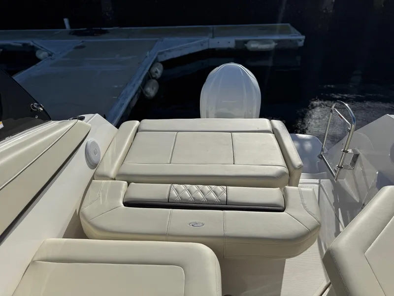 Slide: The Image of 2025 Regal 26 XO boat interior with cushioned seating near dock. - 32