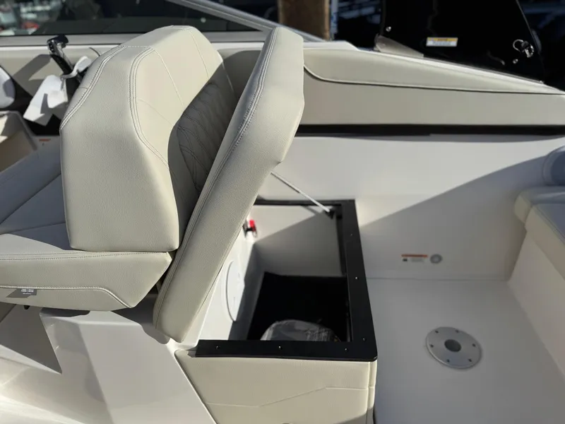 Slide: The Image of 2025 Regal 26 XO boat interior with beige seating and storage compartment. - 35
