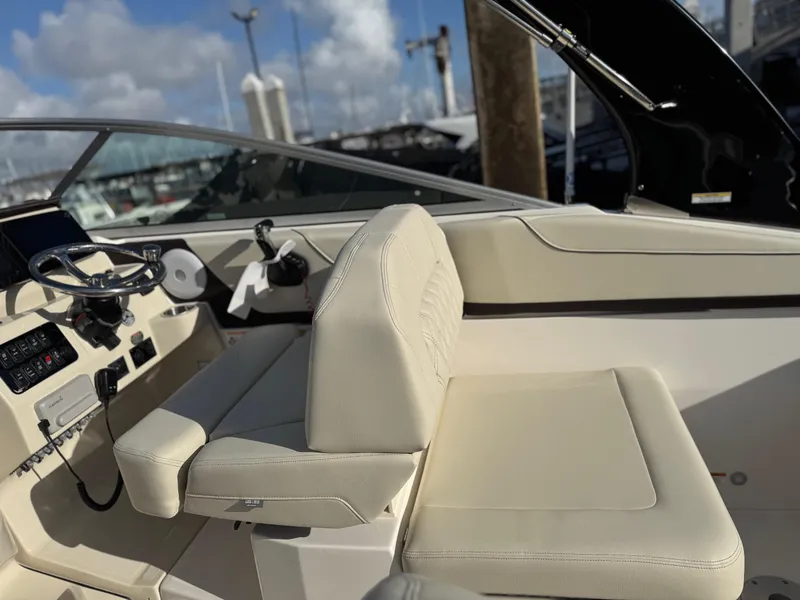 Slide: The Image of 2025 Regal 26 XO boat interior with beige seating and modern dashboard controls. - 36