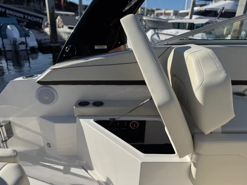 Slide: The Image of 2025 Regal 26 XO boat interior with white seating and control panel at marina. - 37