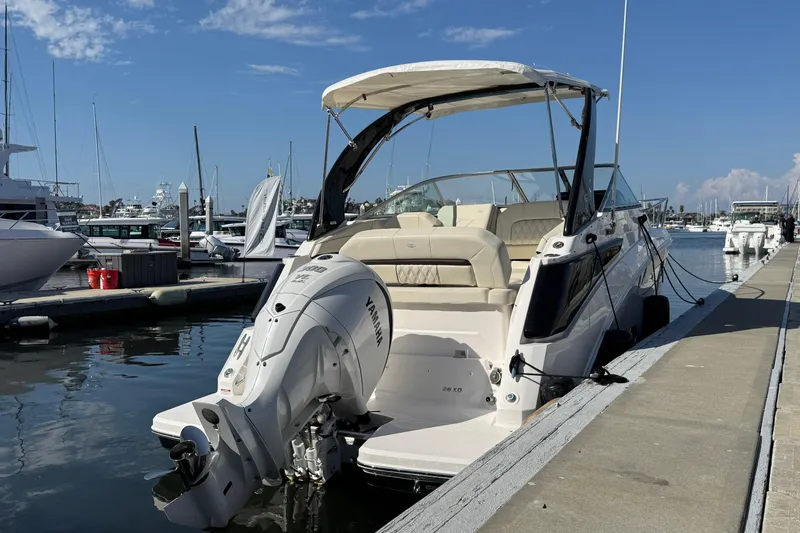 Slide: The Image of 2025 Regal 26 XO boat docked at marina with Yamaha outboard engine. - 4
