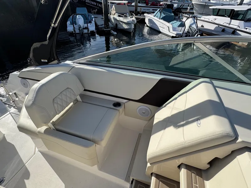 Slide: The Image of 2025 Regal 26 XO boat interior with luxurious seating at a marina. - 41