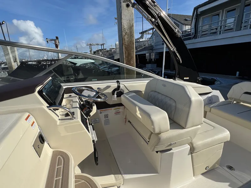 Slide: The Image of Interior of 2025 Regal 26 XO boat, featuring helm and seating area. - 42