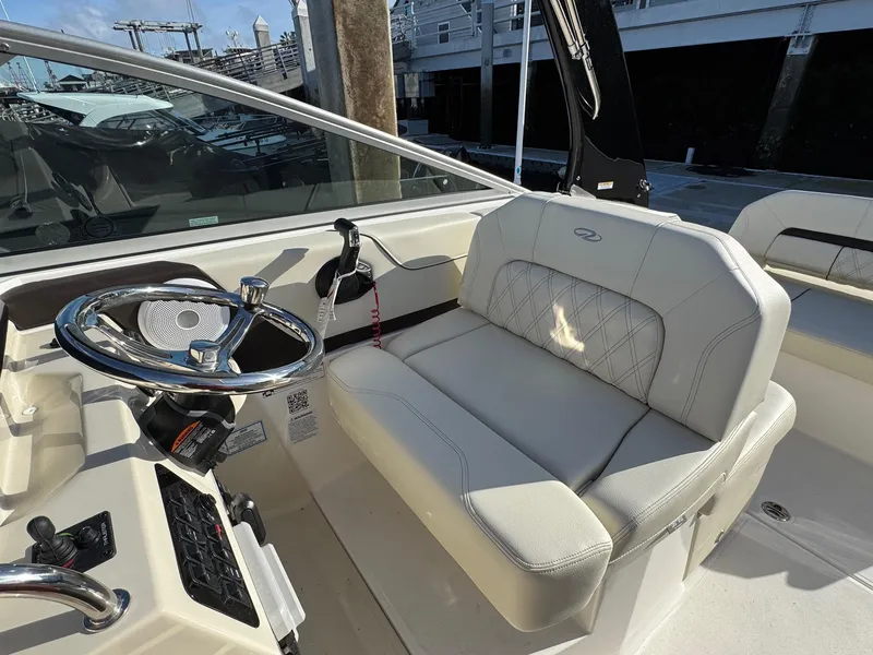 Slide: The Image of 2025 Regal 26 XO boat interior with steering wheel and cushioned seating. - 43
