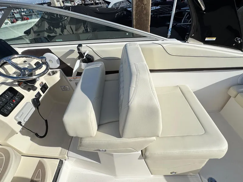Slide: The Image of 2025 Regal 26 XO boat interior with white seating and steering console. - 45