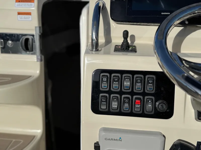 Slide: The Image of 2025 Regal 26 XO boat dashboard with Garmin controls and switches. - 47