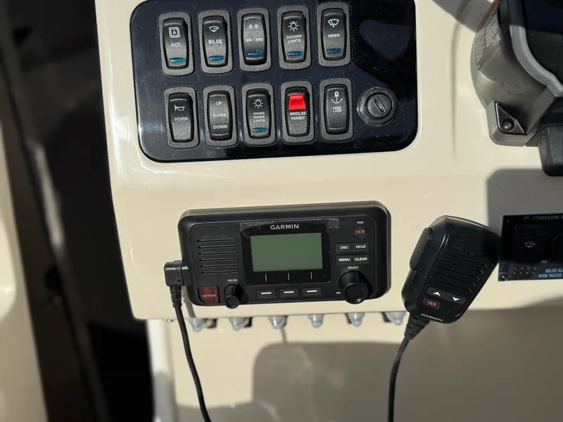 Slide: The Image of Control panel of a 2025 Regal 26 XO boat with Garmin radio and switches. - 48