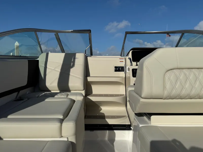 Slide: The Image of 2025 Regal 26 XO boat interior with luxurious seating and clear blue sky background. - 51