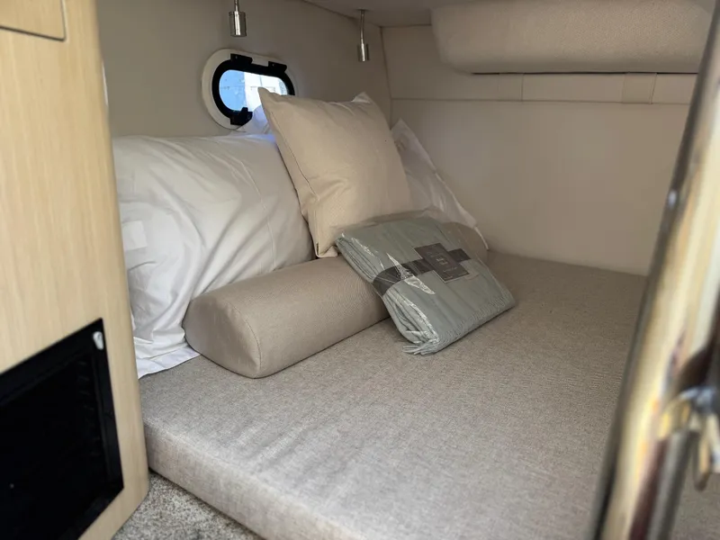 Slide: The Image of Cozy cabin interior of 2025 Regal 26 XO boat with comfortable bedding. - 55