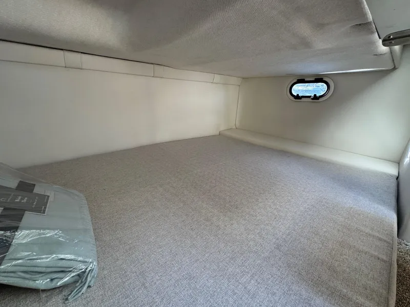 Slide: The Image of 2025 Regal 26 XO cabin interior with bed and small window. - 56