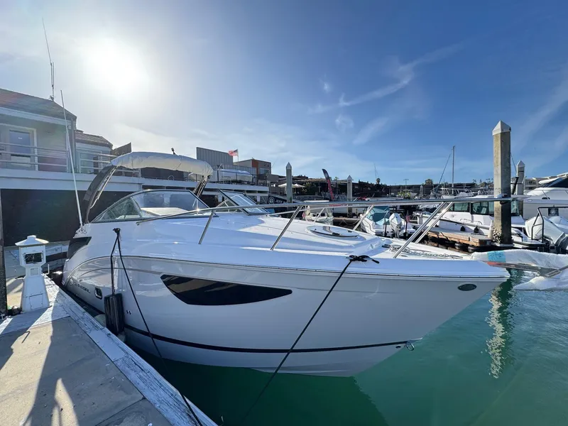 Slide: The Image of 2025 Regal 26 XO boat docked in a sunny marina setting. - 6