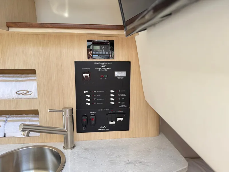 Slide: The Image of Control panel and sink in 2025 Regal 26 XO boat interior. - 60