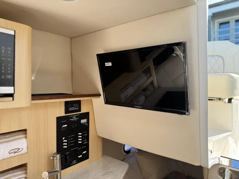 Slide: The Image of 2025 Regal 26 XO interior with mounted TV and control panel. - 62