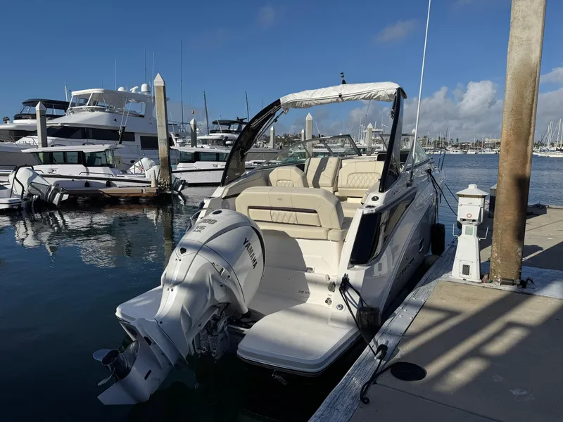 Slide: The Image of 2025 Regal 26 XO boat docked at marina, featuring sleek design and powerful outboard motor. - 7