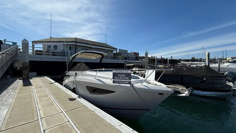 Slide: The Image of 2025 Regal 26 XO boat docked at marina under clear blue sky. - 9