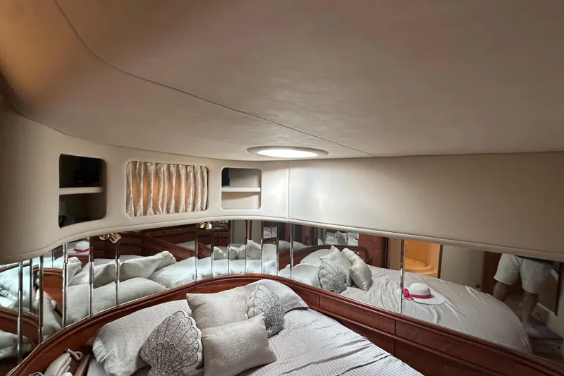 Slide: The Image of Luxurious interior of 2001 Sea Ray 540 Sundancer yacht with elegant bedding and mirrored walls. - 12