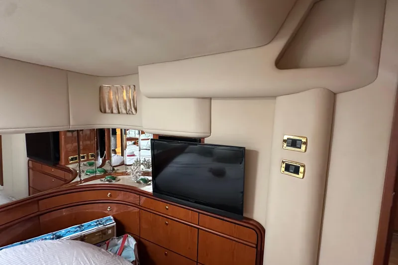 Slide: The Image of Interior of 2001 Sea Ray 540 Sundancer yacht with TV and wooden cabinetry. - 13