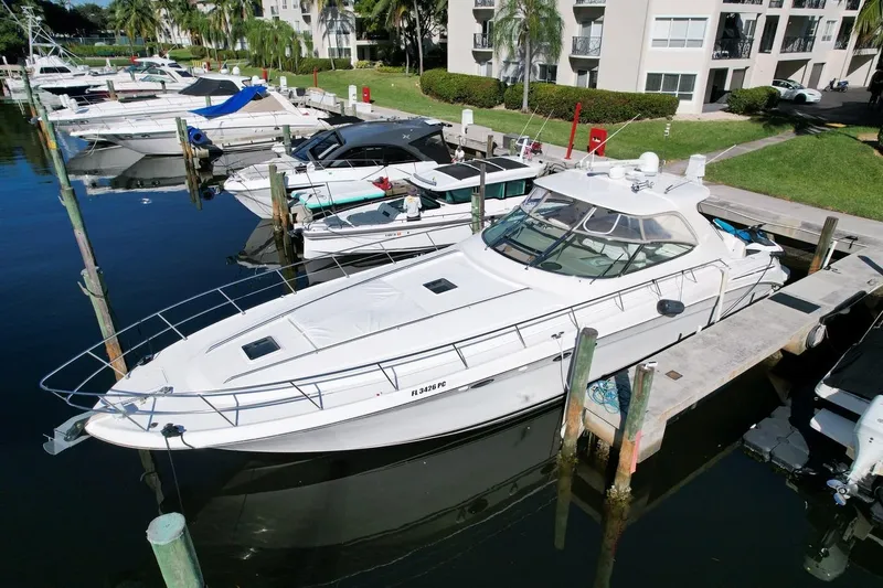 Slide: The Image of 2001 Sea Ray 540 Sundancer yacht docked at marina, surrounded by other boats. - 2