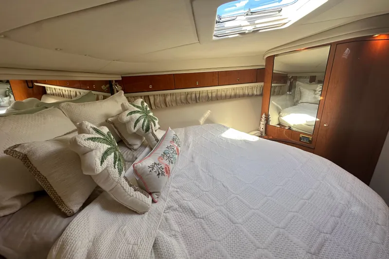 Slide: The Image of Luxurious 2001 Sea Ray 540 Sundancer cabin with elegant bedding and decorative pillows. - 20