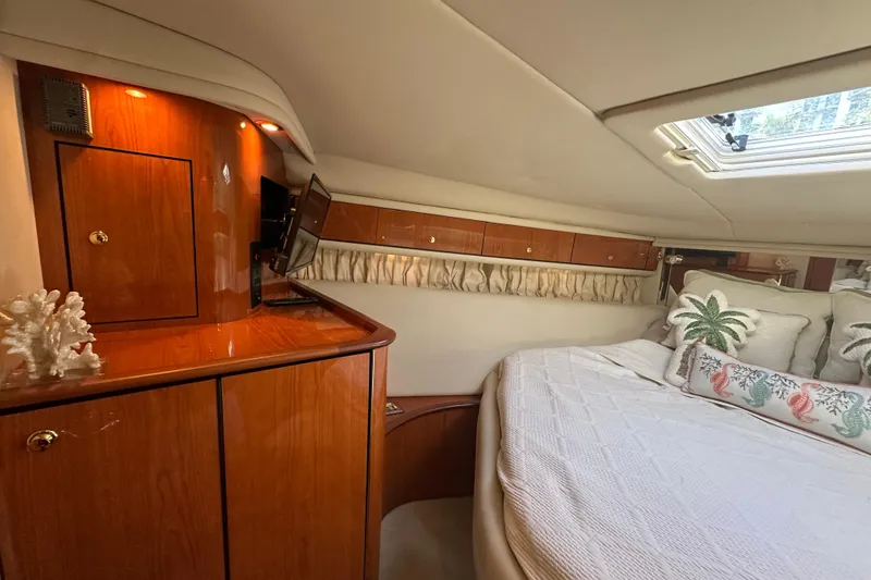 Slide: The Image of Luxurious 2001 Sea Ray 540 Sundancer cabin with elegant wood cabinetry and cozy bedding. - 22