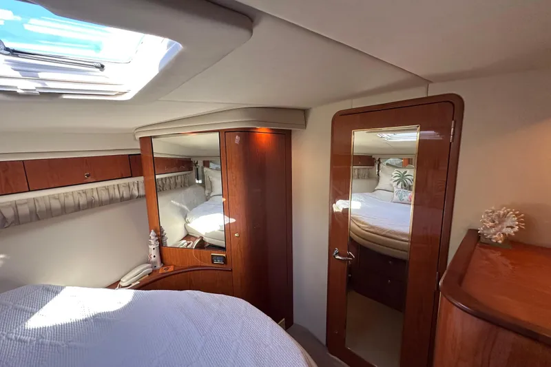 Slide: The Image of Luxurious interior of 2001 Sea Ray 540 Sundancer yacht cabin with elegant wood finishes. - 23
