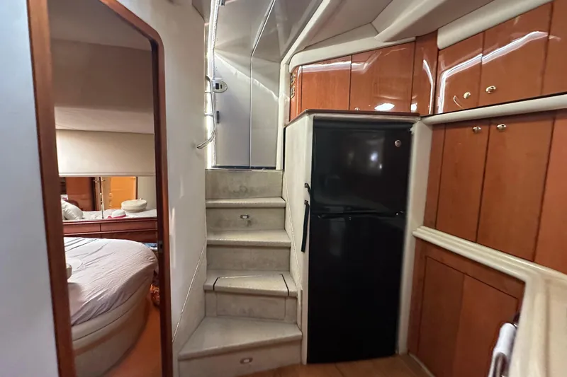 Slide: The Image of Interior of 2001 Sea Ray 540 Sundancer yacht with stairs, cabinets, and bedroom view. - 27