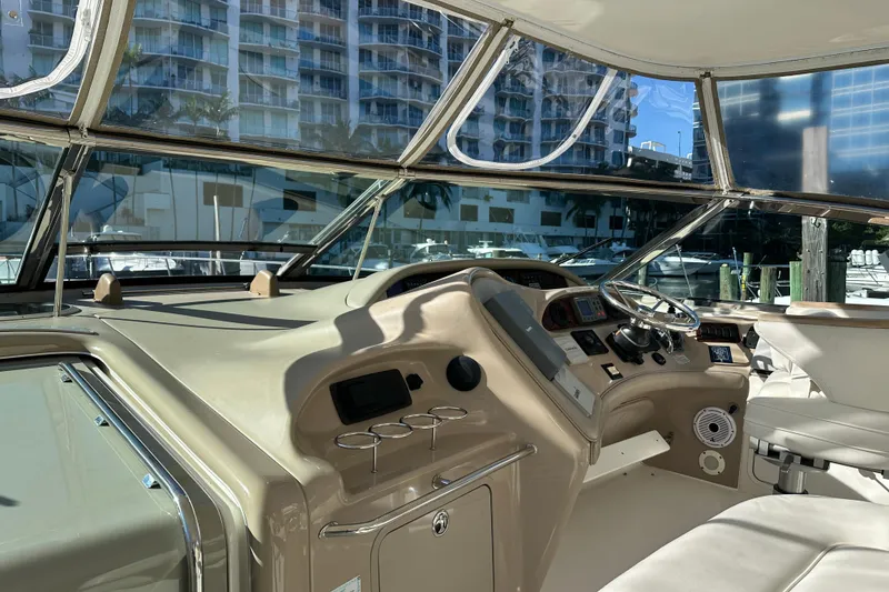 Slide: The Image of 2001 Sea Ray 540 Sundancer helm with modern controls and cityscape view. - 28
