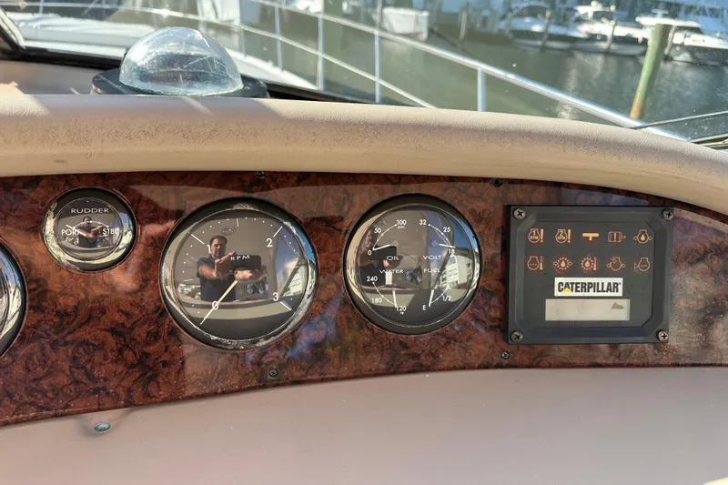 Slide: The Image of Dashboard of a 2001 Sea Ray 540 Sundancer with gauges and Caterpillar display. - 30