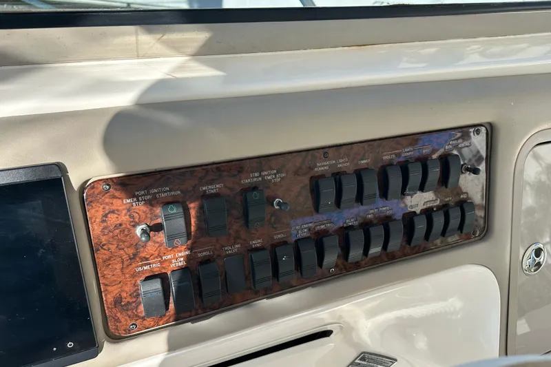 Slide: The Image of Control panel of a 2001 Sea Ray 540 Sundancer yacht with various switches. - 38