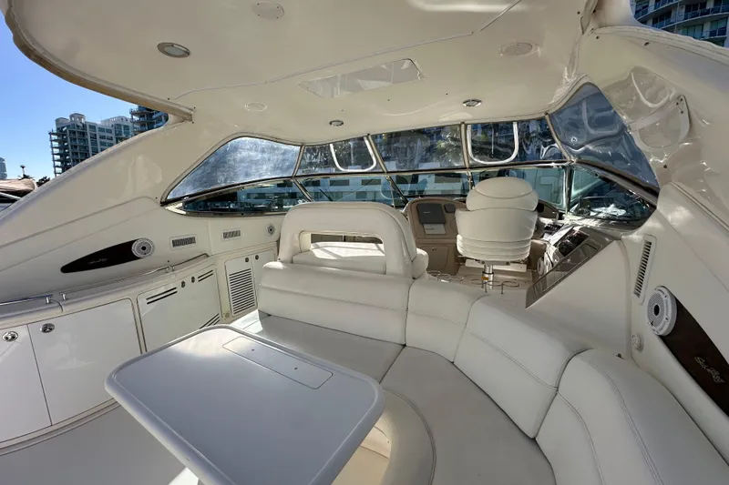 Slide: The Image of Luxurious interior of 2001 Sea Ray 540 Sundancer yacht with white seating and helm. - 41