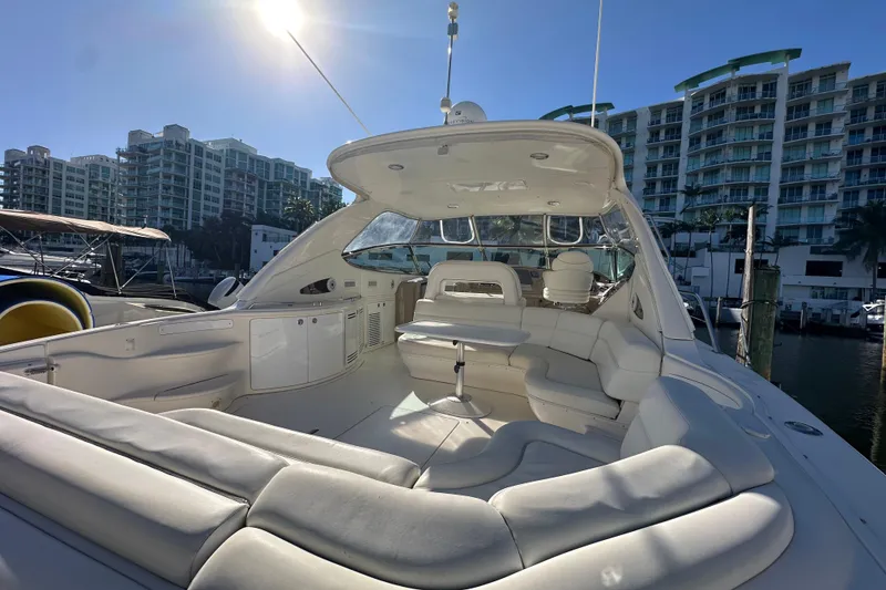 Slide: The Image of Luxurious 2001 Sea Ray 540 Sundancer yacht docked near modern waterfront buildings. - 43
